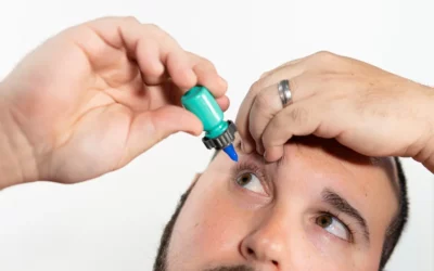 save money on eye drops - man using the Nanodropper device from SureVision Eye Centers